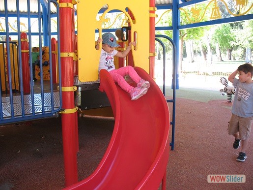 a kid is going down the slide